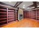 Living room featuring hardwood floors, stone fireplace, and custom built-in bookshelves at 4002 Moheb Sw St, Atlanta, GA 30331