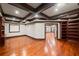 Living room featuring hardwood floors, coffered ceilings, and custom built-in bookshelves at 4002 Moheb Sw St, Atlanta, GA 30331