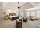 Spacious main bedroom with tray ceiling, ceiling fan, and sitting area at 4002 Moheb Sw St, Atlanta, GA 30331
