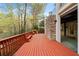 An open deck with built-in benches on a house with brick and stone exterior and views of the surrounding forest at 4002 Moheb Sw St, Atlanta, GA 30331