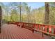 Large open deck with built-in benches offering peaceful views of the surrounding wooded landscape at 4002 Moheb Sw St, Atlanta, GA 30331