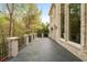 Large patio featuring stone pavers, a decorative railing, and a partial brick exterior at 4002 Moheb Sw St, Atlanta, GA 30331