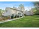 Spacious backyard with lush lawn, mature trees, and a well-maintained exterior at 4522 Willow Oak Trl, Powder Springs, GA 30127
