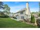 Back exterior of the house featuring a patio, a yard, and lush landscaping at 4522 Willow Oak Trl, Powder Springs, GA 30127