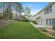 Large backyard featuring lush green lawn, patio, and mature trees at 4522 Willow Oak Trl, Powder Springs, GA 30127