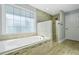 Bright bathroom featuring a large soaking tub under a window and a separate glass-enclosed shower at 4522 Willow Oak Trl, Powder Springs, GA 30127