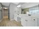 Bathroom with dual sinks, white cabinets and a large mirror at 4522 Willow Oak Trl, Powder Springs, GA 30127