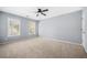 Spacious bedroom with neutral walls, plush carpeting, and two windows providing natural light at 4522 Willow Oak Trl, Powder Springs, GA 30127