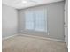 Neutral bedroom featuring plush carpeting, a ceiling fan, and a window providing natural light at 4522 Willow Oak Trl, Powder Springs, GA 30127