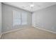 Neutral bedroom with ceiling fan, a large window, and carpet floors at 4522 Willow Oak Trl, Powder Springs, GA 30127