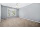 Well-lit bedroom with a ceiling fan and a large window offering an outdoor view at 4522 Willow Oak Trl, Powder Springs, GA 30127