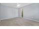A large bedroom featuring neutral walls and carpet and a single entry door at 4522 Willow Oak Trl, Powder Springs, GA 30127