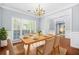 Dining room with hardwood floors, paneled walls and a wood table set for dinner at 4522 Willow Oak Trl, Powder Springs, GA 30127