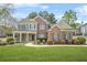 Charming brick two-story home with a manicured lawn and inviting front porch at 4522 Willow Oak Trl, Powder Springs, GA 30127