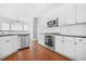 Bright kitchen features white cabinets, stainless steel appliances, and sleek countertops at 4522 Willow Oak Trl, Powder Springs, GA 30127
