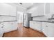 The kitchen includes white cabinets, stainless steel refrigerator, and wood floors at 4522 Willow Oak Trl, Powder Springs, GA 30127