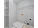Functional laundry room with ample storage, shelving, and utility sink at 4522 Willow Oak Trl, Powder Springs, GA 30127