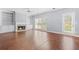Bright living room with a fireplace and built-in shelves, showcasing the hardwood floors at 4522 Willow Oak Trl, Powder Springs, GA 30127