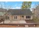 Backyard view with a patio and brick-lined garden beds, offering a private and relaxing outdoor space at 475 Brown Thrasher Ct, Alpharetta, GA 30009