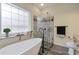 Bright bathroom featuring freestanding tub, walk-in shower and large window at 475 Brown Thrasher Ct, Alpharetta, GA 30009