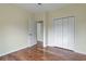 Bedroom with hardwood floors, double closet, and an ensuite bathroom at 475 Brown Thrasher Ct, Alpharetta, GA 30009