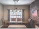 Bright dining room featuring a wood table with a bench and an exposed brick wall at 475 Brown Thrasher Ct, Alpharetta, GA 30009