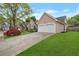 Beautiful home featuring an attached two-car garage and well-maintained lawn and landscaping at 475 Brown Thrasher Ct, Alpharetta, GA 30009
