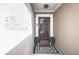 Inviting entryway featuring a modern wood door, sleek black and white rug, and stylish potted plants at 475 Brown Thrasher Ct, Alpharetta, GA 30009