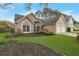 Inviting single-story home showcasing a well-manicured lawn, landscaping, and a two-car garage at 475 Brown Thrasher Ct, Alpharetta, GA 30009