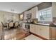 Charming kitchen and dining area with white cabinets, brick backsplash, and stainless steel appliances at 475 Brown Thrasher Ct, Alpharetta, GA 30009
