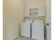 Functional laundry room with washer, dryer, and storage cabinets at 475 Brown Thrasher Ct, Alpharetta, GA 30009