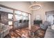 Open-concept layout with bar seating, hardwood floors, modern chandelier, and comfortable furniture at 475 Brown Thrasher Ct, Alpharetta, GA 30009