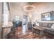 Spacious living room featuring hardwood floors, a modern chandelier, and comfortable seating at 475 Brown Thrasher Ct, Alpharetta, GA 30009