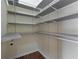 Walk-in closet with custom shelving and wood floors at 475 Brown Thrasher Ct, Alpharetta, GA 30009