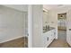 Bathroom featuring a granite-topped vanity and a walk-in closet at 60 Riverside Pkwy, Sharpsburg, GA 30277