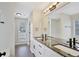 Bathroom featuring a granite-topped double vanity and modern fixtures at 60 Riverside Pkwy, Sharpsburg, GA 30277
