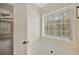 Bright bathroom with a garden tub under a large window with wooded view at 60 Riverside Pkwy, Sharpsburg, GA 30277