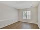Cozy bedroom featuring wood-look floors, large window, and white brick wall at 60 Riverside Pkwy, Sharpsburg, GA 30277