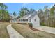This lovely home features an attached two-car garage, mature trees and an expansive front yard at 60 Riverside Pkwy, Sharpsburg, GA 30277
