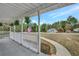 Inviting front porch with ferns, white railings, and a walkway leading to the yard, offering a relaxing outdoor space at 60 Riverside Pkwy, Sharpsburg, GA 30277