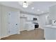 Bright kitchen features all-white cabinetry, stainless steel appliances, and wood-look floors at 60 Riverside Pkwy, Sharpsburg, GA 30277