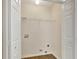 Bright laundry room with white walls, wood-look flooring, and laundry hook-ups at 60 Riverside Pkwy, Sharpsburg, GA 30277