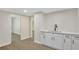 Bright room with stylish white cabinets and drawers and wood-look flooring at 60 Riverside Pkwy, Sharpsburg, GA 30277