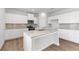 Modern kitchen featuring white cabinets, granite countertops, and a center island at 7182 Brushwood Bend (Lot 114), Lithonia, GA 30058