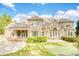 Stunning backyard with a pool, putting green, patio, and manicured lawn, highlighting the estate's luxury at 2281 Bransley Pl, Duluth, GA 30097