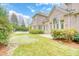 Expansive backyard with a putting green, lush lawn, and patio area, showcasing the home's exterior at 2281 Bransley Pl, Duluth, GA 30097