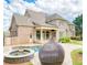 Backyard featuring a pool, spa, lush landscaping, and a charming exterior view of the house at 2281 Bransley Pl, Duluth, GA 30097