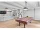 Finished basement area with a pool table, large sectional sofa, and home gym equipment at 2281 Bransley Pl, Duluth, GA 30097