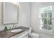 Charming powder room features an ornate mirror and marble countertop at 2281 Bransley Pl, Duluth, GA 30097