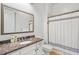 Bathroom featuring marble countertops, dark fixtures, and a shower with white shower curtain at 2281 Bransley Pl, Duluth, GA 30097